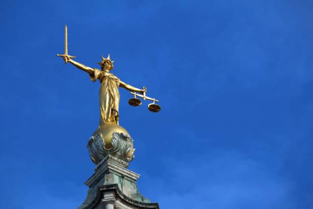 istock Justice statue atop court in London 1392738996