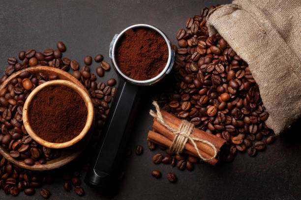 istock Roasted coffee beans and ground coffee in filter holder 1392739076
