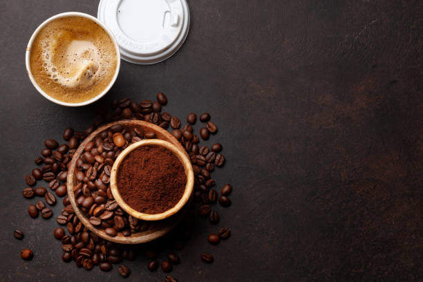 Takeaway cup, roasted coffee beans and ground coffee