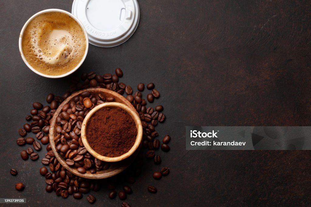 Takeaway cup, roasted coffee beans and ground coffee Fresh coffee in takeaway cup, roasted coffee beans and ground coffee. Top view flat lay Coffee - Drink Stock Photo
