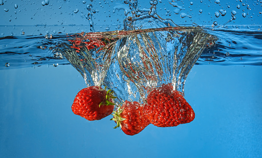 Strawberry splash on water