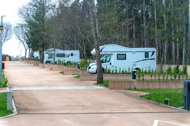 Several caravans parked early in the morning inside a campsite resting and resupplying. Concept of traveling on the road. stock photo