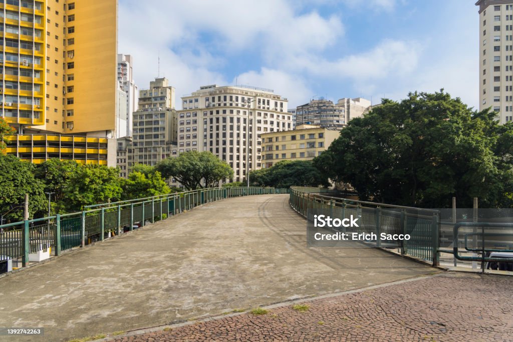 Footbridge with buildings in downtown Sao Paulo in the background, Bandeira bus terminal Street Stock Photo