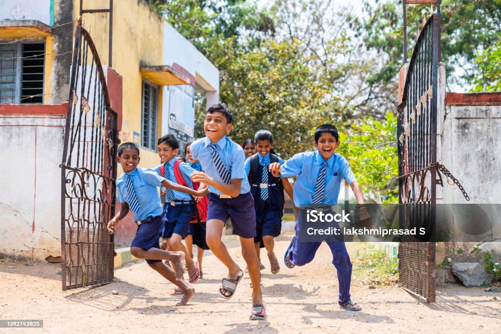 Children running out from school by opening gate after the bell - concept of education, freedom, happiness, enjoyment and childhood growth. Children running out from school by opening gate after the bell - concept of education, freedom, happiness, enjoyment and childhood growth India Stock Photo