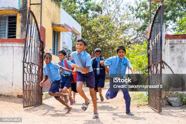 Children Running Out From School By Opening Gate After The Bell Concept Of Education Freedom Happiness Enjoyment And Childhood Growth Stock Photo - Download Image Now
