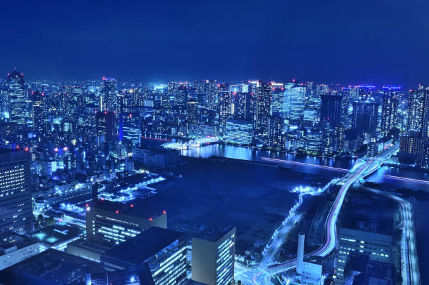 night view of shiodome from kaletta shiodome, kachidoki bridge (kachidoki bridge), light tail of tsukiji ohashi bridge - shiodome urban scene blurred motion tokyo prefecture imagens e fotografias de stock