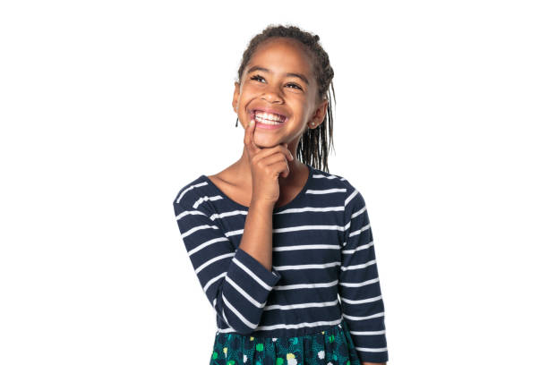 Adorable african little girl on studio white background thinking stock photo