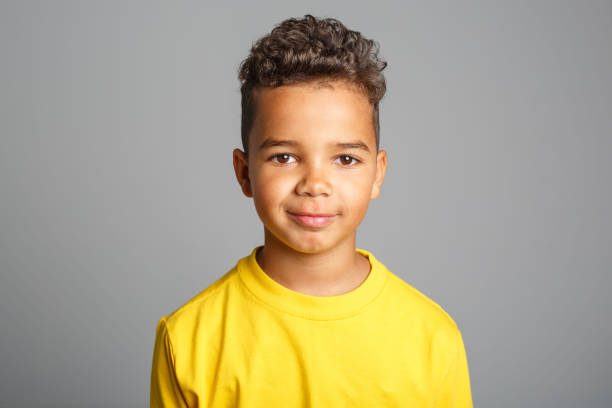 istock Adorable african boy on studio white background 1392744146