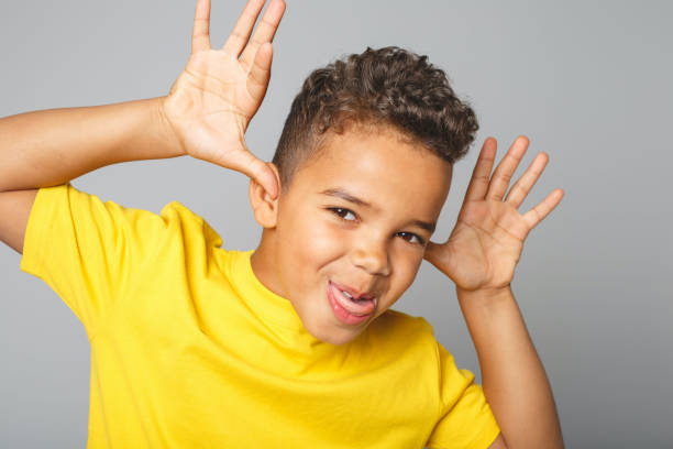 istock Adorable african boy on studio gray background doing grim 1392744206