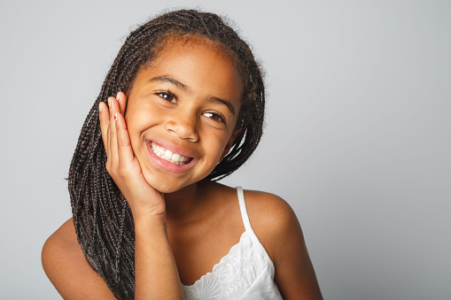 An Adorable african little girl on studio white background