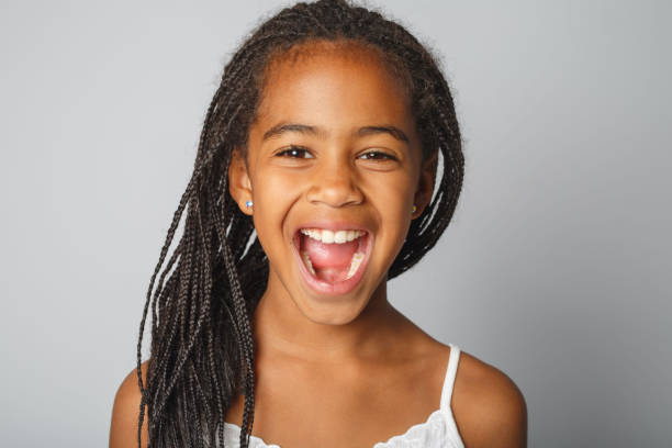 istock Adorable african little girl on studio white background screaming 1392744331