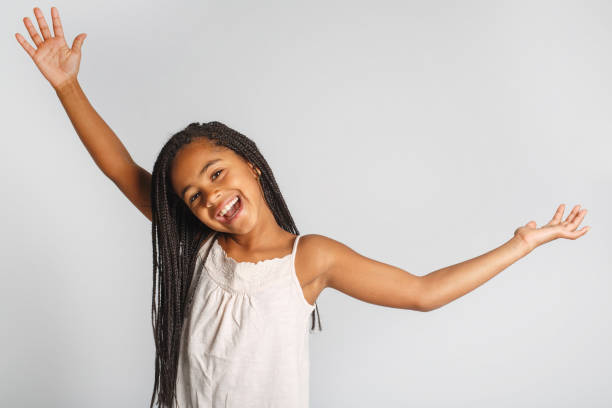 istock Adorable african little girl on studio white background 1392744336