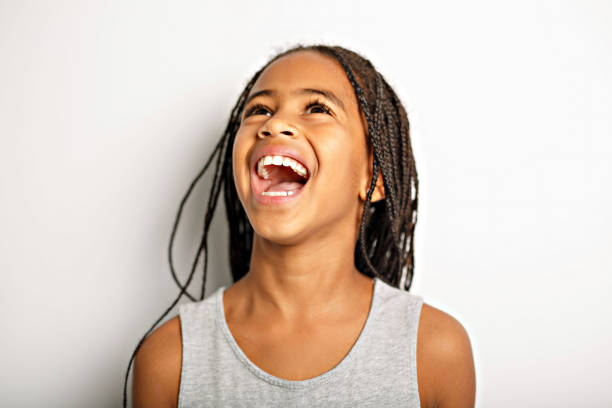 istock Adorable african little girl on studio white background 1392744392