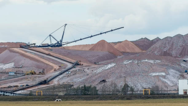 istock Giant spreader or absetzer machinery. A large dumper on a landfill with potash ore. Extracting potassium salts. 1392746092