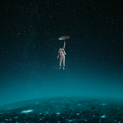 Contemporary art collage. Young man falling down with umbrella on space land. Conceptual image. Creativity, Fly of thoughts, dreams. Concept of imagination, inspiration, surrealism