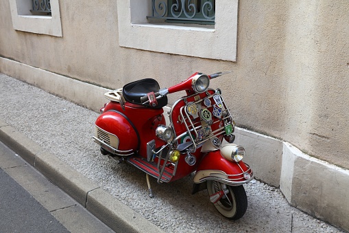 Oldtimer retro Piaggio Vespa scooter parked in Arles, France.