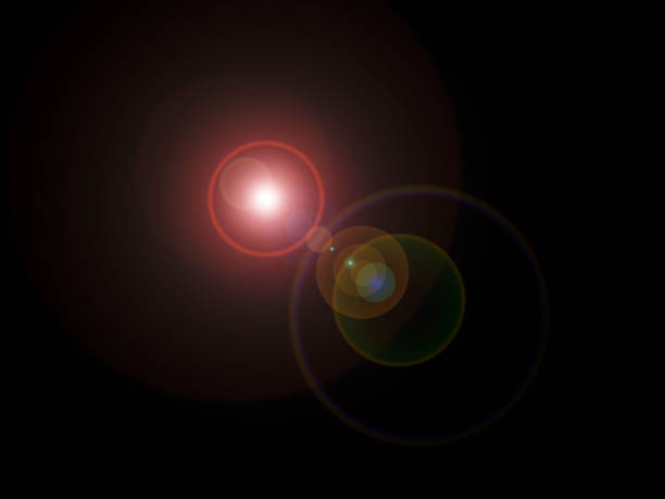 istock Lens flare looking like multi-colored cosmic spheres of light and reflected light in various sizes centered black background stock 1392747744