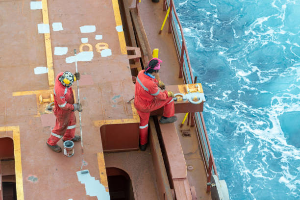 5th October, 2025 - Port workers attaching a securing rope from a cruise ship to bollards on the harbour quay in Getxo, Northern Spain