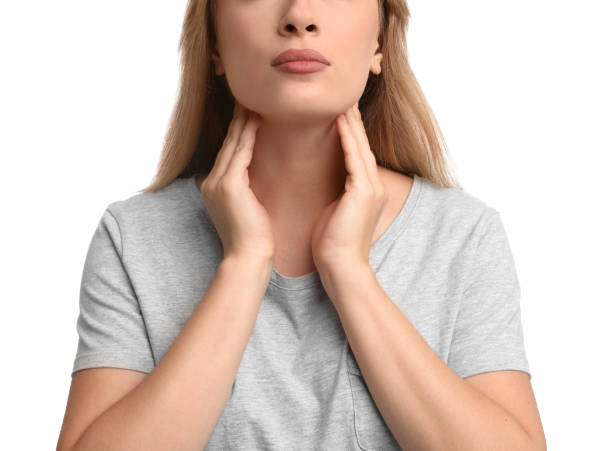 istock Young woman doing thyroid self examination on white background, closeup 1392748851