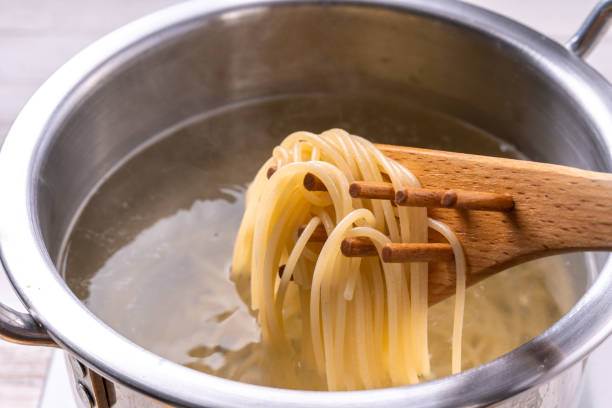Scoop pasta with pasta ladle stock photo