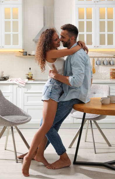 istock Lovely couple enjoying time together in kitchen 1392749671