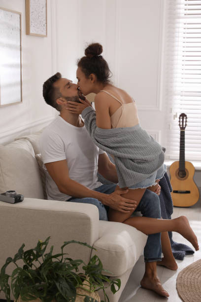 istock Lovely couple enjoying each other on sofa at home 1392749917