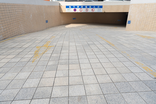 Warsaw, Poland- 01.02.2023: The sidewalk is paved with granite tiles against the background of a pedestrian crossing.