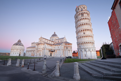 Pisa, Italy - December 17, 2021: The Leaning Tower of Pisa in the Square of Miracles. The world famous tower began to lean during construction in the 12th century.