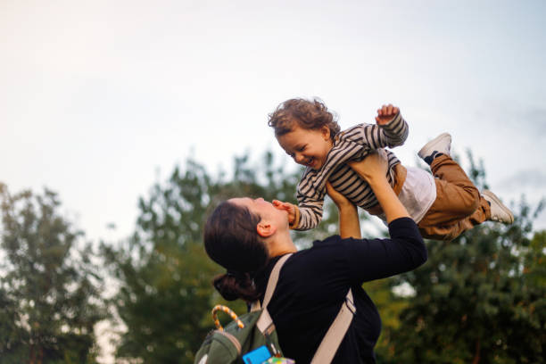 istock Mom has fun with her little boy at sunset 1392754618
