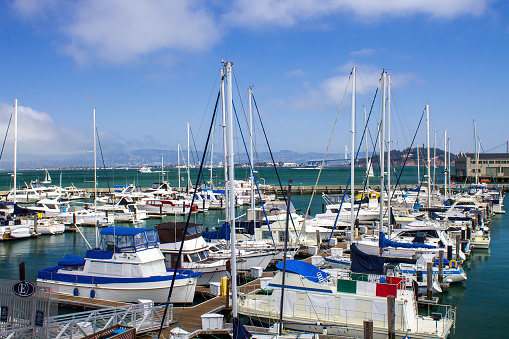Marina with many boats in San Francisco. Blue sky with few clouds.