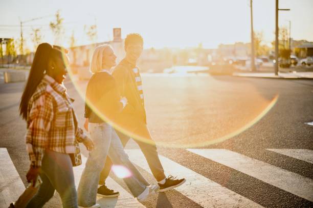 istock Group of friends walking on zebra crossing 1392757201