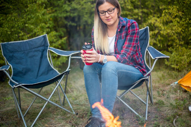 istock Woman resting at camp in the forest 1392760418