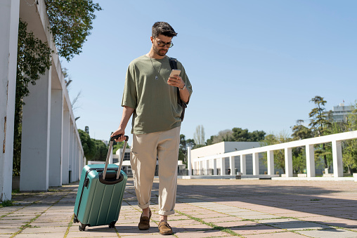 Young man traveling with luggage.