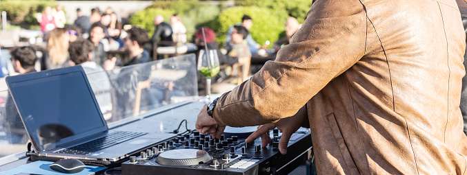 Horizontal banner or header with disc jockey playing music for tourist people at club party outdoor - Live event, music and fun concept - Entertainment and party concept