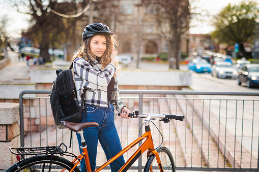 Young woman enjoys springtime with bicycle in the city