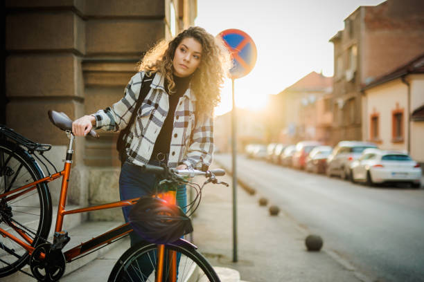 istock Woman prepares for cycling after work 1392767275