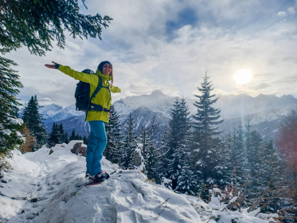Young woman snowshoeing in winter stock photo