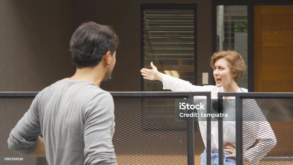 An angry neighbor shouting, blaming, yelling at each other in their homes in village. People. Neighborhood argument Neighbor Stock Photo