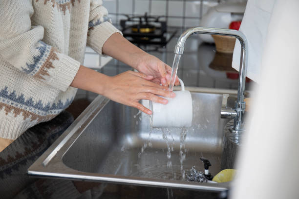 istock woman's hand washing dishes 1392773879
