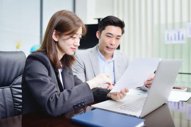 istock Two Young Colleagues Working in Meeting Room 1392773935
