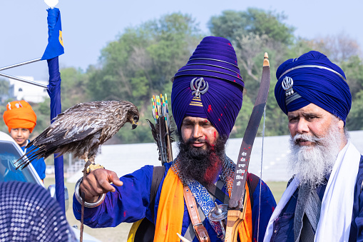 Anandpur Sahib, Punjab, India - March 2022: Portrait of indian sikh male celebrating the hola mohalla festival during holi festival at anand pur sahib.