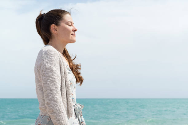 istock Relaxed woman breathing fresh air. 1392774173