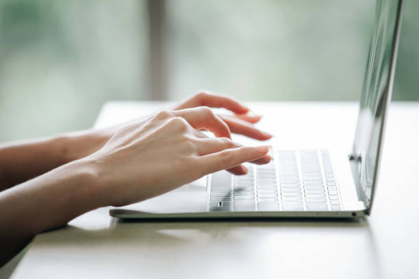 istock Female person typing on laptop. 1392774315