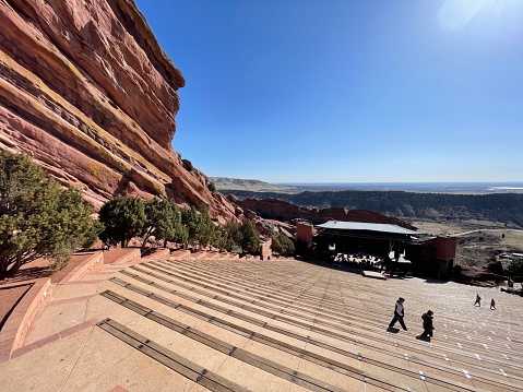 Golden, Colorado - 04-14-2022: Unidentified people walking and running in the Red Rocks Amphitheater in Golen, Colorado