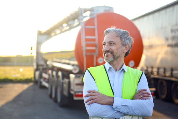 Fuel tank driver Adult male fuel truck driver. About 50 years old, Caucasian male. oil tanker stock pictures, royalty-free photos & images