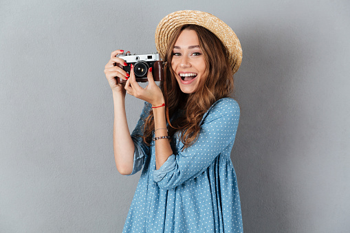 Image of happy young caucasian woman photographer holding camera.