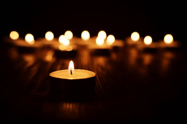 burning candle over black background - holocaust imagens e fotografias de stock