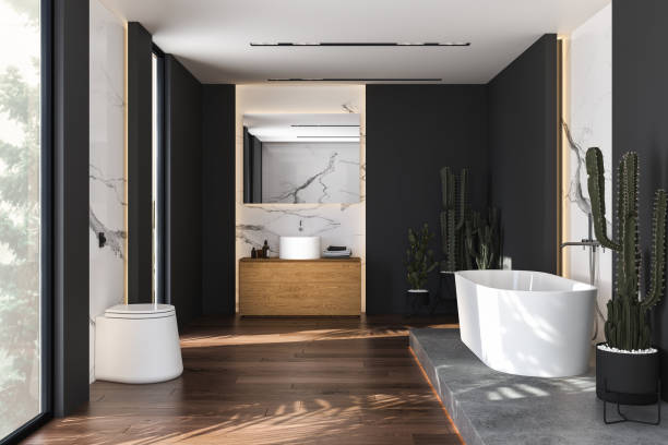 istock Black and marble bathroom interior with a white bathtub standing on a concrete platform. 1392784197