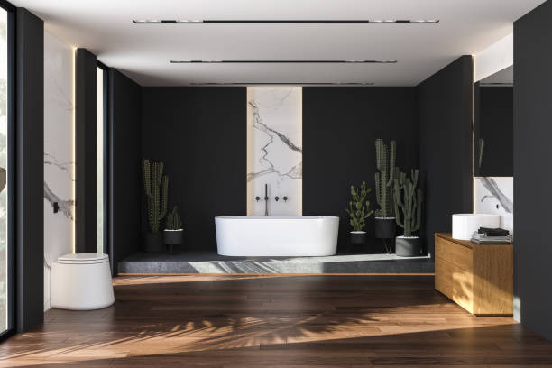 istock Black and marble bathroom interior with a white bathtub standing on a concrete platform 1392784333