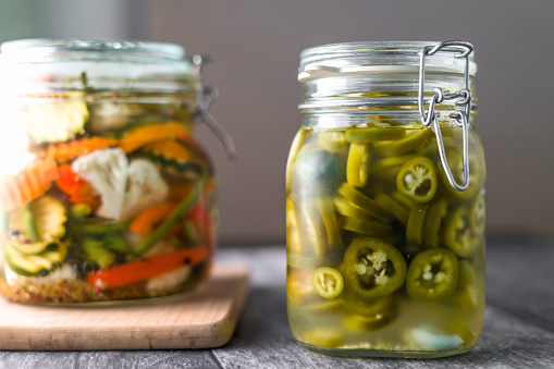 Glass mason jar with pickled vegetables.